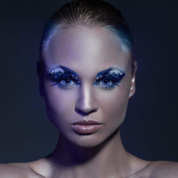 Portrait of beautiful caucasian young woman with artistic makeup